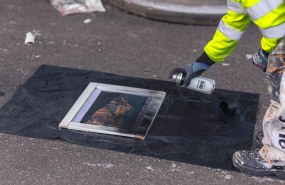 Opiskelija spreimaalaa taulua palaneen näköiseksi